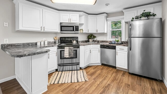 Elegant stainless steel appliances add modern style to our charming kitchens at The Willows. - The Willows