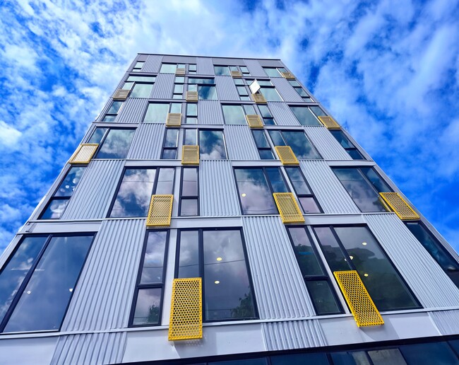 Impressive facade of a tall building with a blue sky at Alt Capitol Hill.