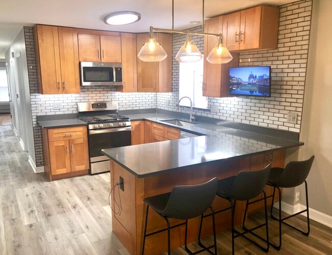 New cabinets, 42” uppers with under lit cabinets, all new S/S Appliances with outdoor vented hood. - 771 56th St Unit 1st Floor