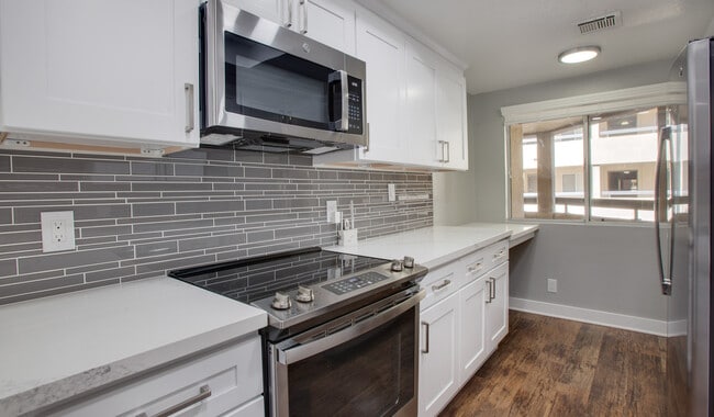 Kitchens with granite countertops and wood flooring