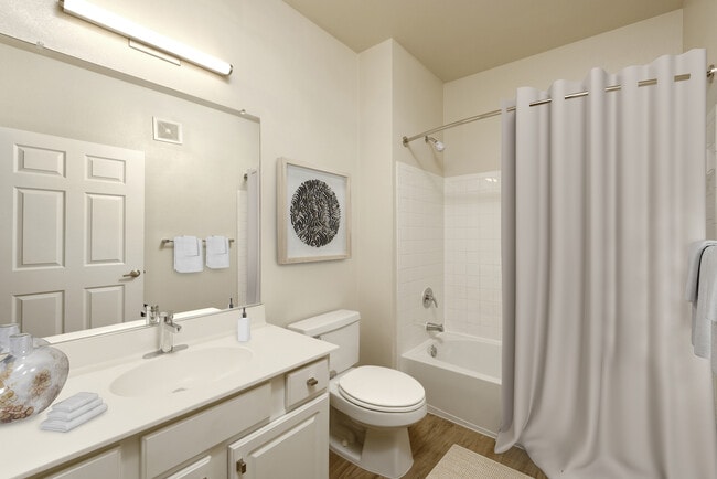 Renovated Package I bath with white countertops, white cabinetry, and hard surface flooring
