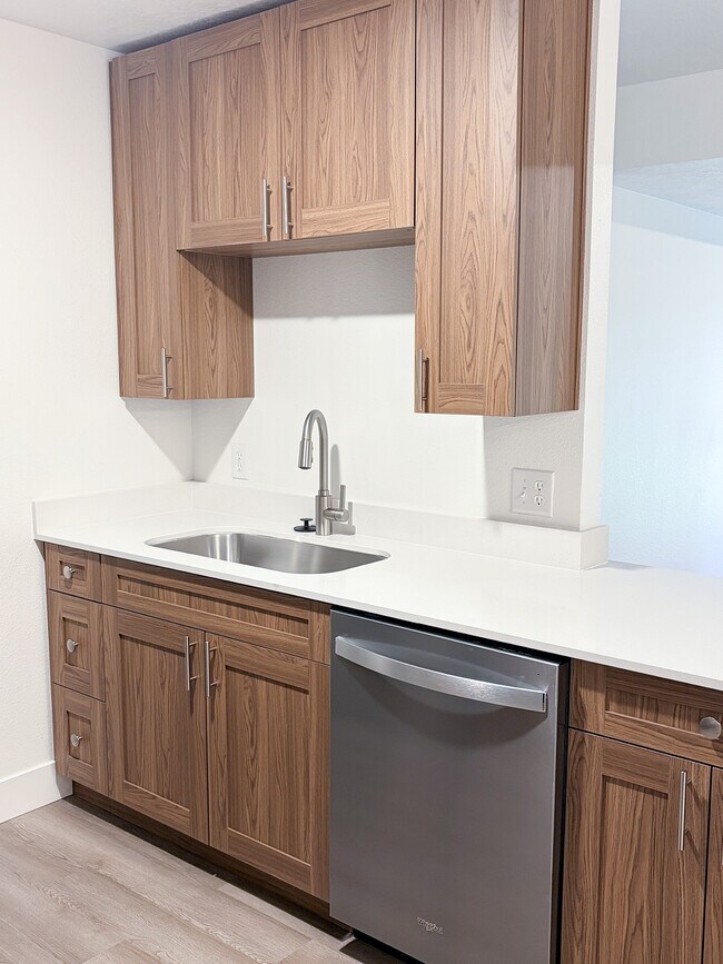 Freshly renovated kitchens featuring sleek countertops, upgraded fixtures, and abundant cabinet storage. - Pinebrook