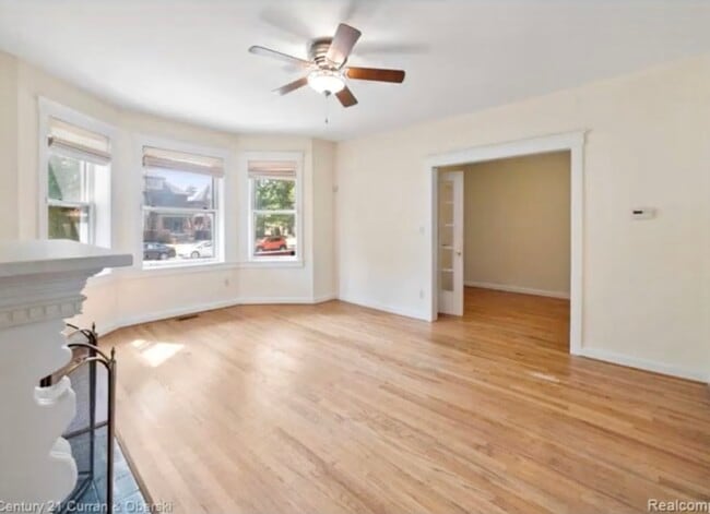Living Room w/ Bay Windows & Fireplace! - 455 E Ferry St Unit 1