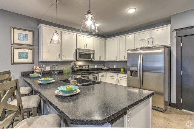 Modern kitchens with sleek appliances and granite countertops offer the ideal setup for cooking and entertaining. - The Helen Rental