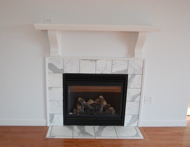 Working fireplace with marble surround in living room. - 485 Elmwood Ave Unit 6