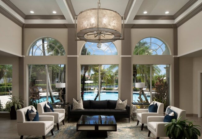 Tall windows bring poolside views into the clubhouse lounge.