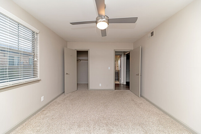 Cozy bedroom with carpet & ceiling fan