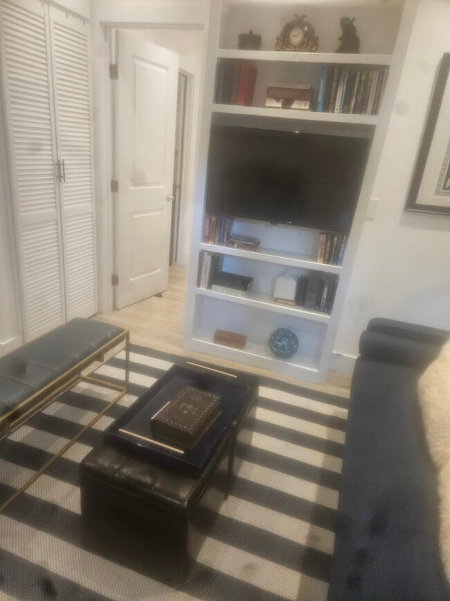 View of the television. Note the sunlight on the floor is from the 2 windows sunlite on the floor