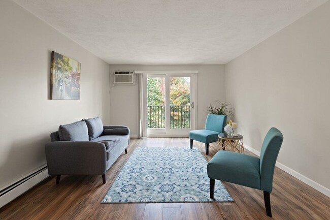 Living room with sliding door to balcony, new flooring, baseboard, and paint - 9 Kenmar Dr Rental