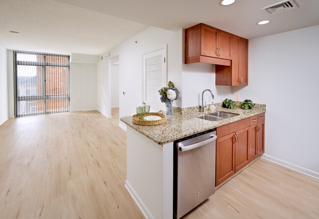 The open-concept living area flows seamlessly into the separate sleeping nook, unified by new vinyl plank wood-style flooring throughout. A Google NEST thermostat and updated contemporary lighting enhance the modern feel of this 578-square-foot layout. - Meridian at Grosvenor Station