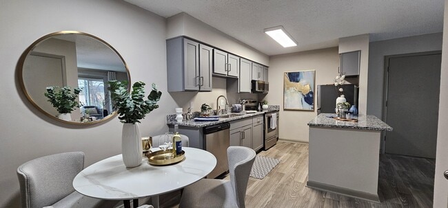 Kitchen with granite counters and modern cabinetry - Kinley Flats Apartments