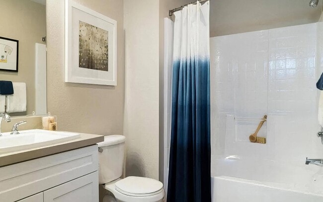 Modern Bathroom with White Vanity and Sleek Fixtures - Amerige Pointe Rental