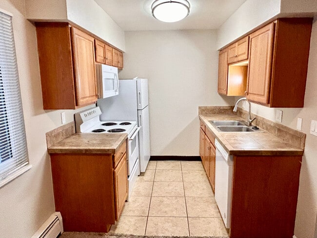 Charming kitchen with modern appliances and elegant wooden cabinetry, offering a cozy and functional cooking space.