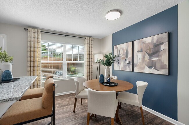 Dining area with hardwood-style flooring & overhead lighting
