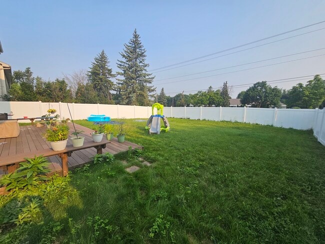 Fenced in backyard currently with privacy fence added. - 22 Brighton Cir