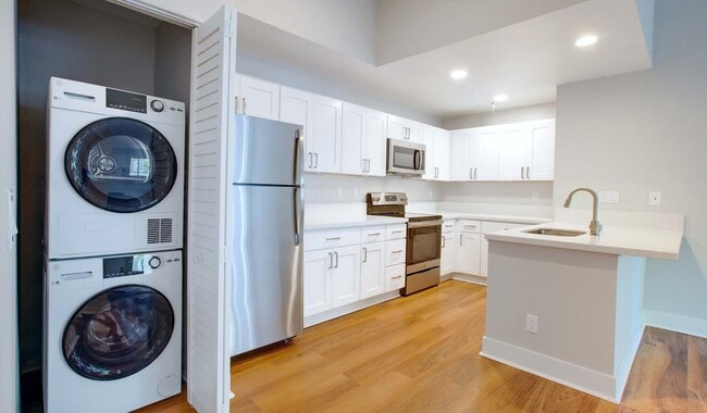 Renovated kitchens with stackable laundry in-unit.