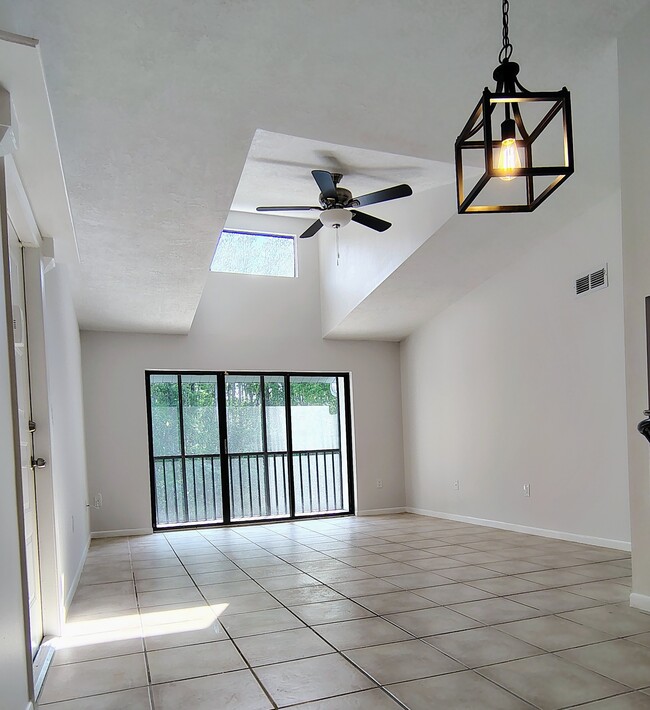 Vaulted ceiling over LR w/view of balcony and preserve in morning sun - 1353 Pine Ridge Cir E Unit 128 E3