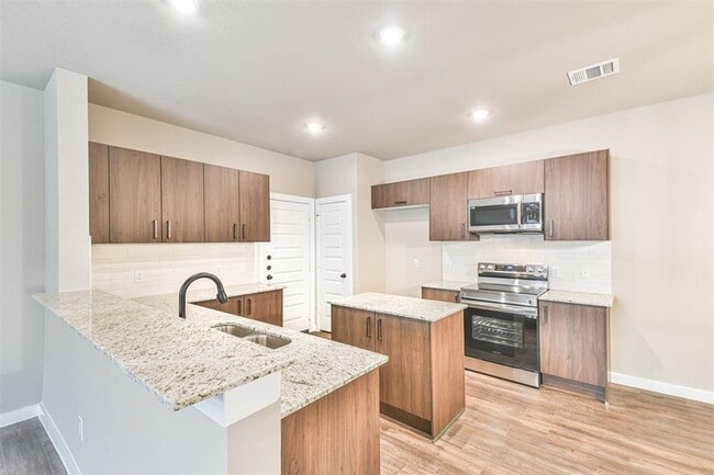 Photo - Modern 3-Bedroom Duplex with Granite Counters, Private Yard, and Prime Location