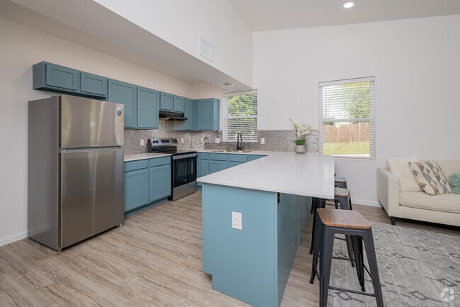 Common Area - Furnished Kitchen Island With Bar Chairs