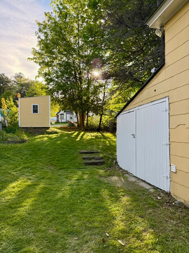 two storage sheds: a lean-to at the back of the house and a free-standing shed on Luxton St.