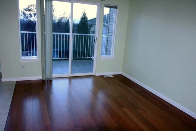 Living room with small balcony overlooking city skyline - 2680 139th Ave SE