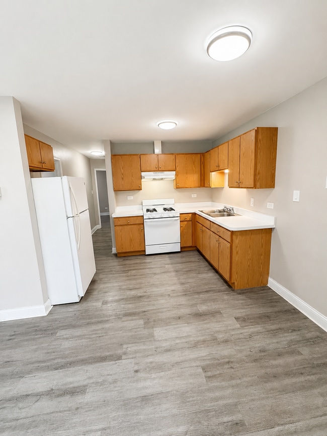 Photo - Updated 2-bedroom apartment with parking, front/rear access, modern flooring, full kitchen, and l... Unit C
