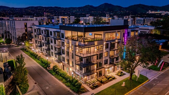 Liberty Duet Apartments, Salt Lake City, Utah; exterior well-lit front at night. - Liberty Duet Rental