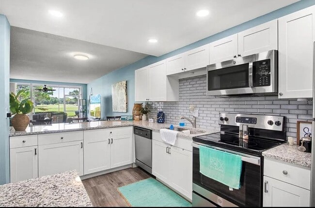 Photo - Annual OR Seasonal turnkey FURNISHED 2/2 ground floor condo with golf course and water views