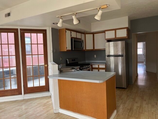 From living room to kitchen, french doors to outdoor deck, hallway to bedrooms - 2328-2 E Carson St Unit 2328 E Carson 2nd Floor