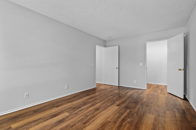 Spacious bedrooms with wood plank flooring