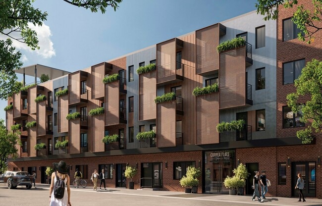 Entrance featuring large outdoor balconies and corten steel design - Copper Flats Apartments