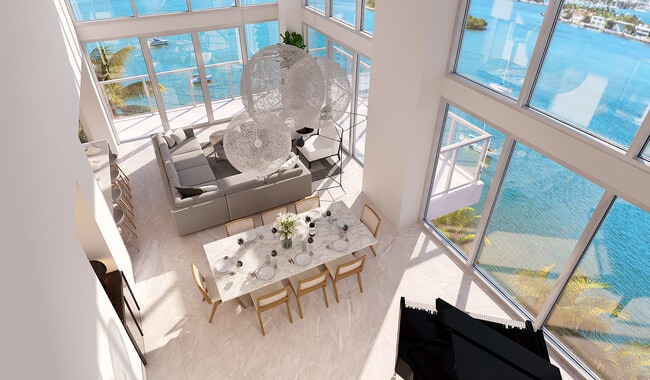 Double-height windows usher in fantastic Biscayne Bay views. - Flamingo Point Apartments