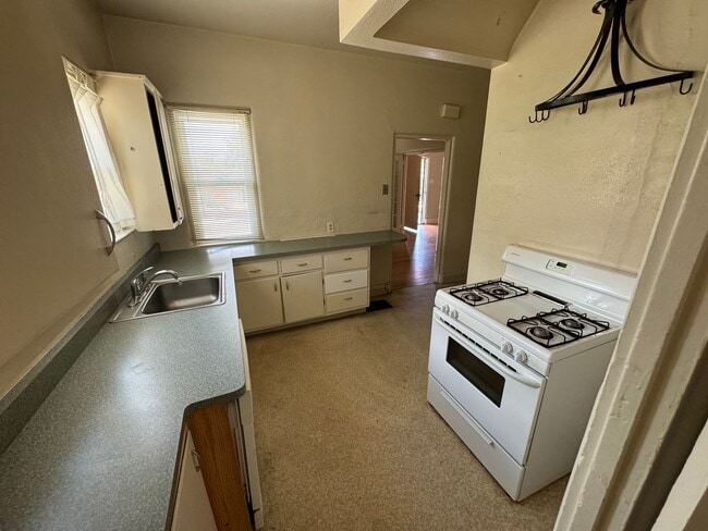 Photo - 4 Br, 2 Ba with kitchen appliances and bas...