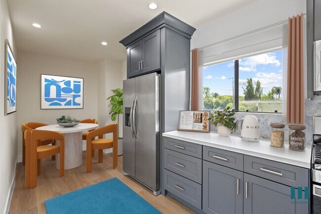 Kitchen with Stainless-Steel Appliances and Dining Area - Penmar Superba by Wiseman