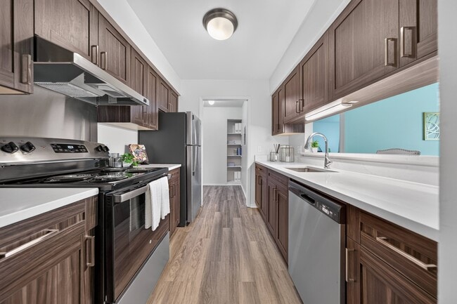 Modern kitchen with stainless steel appliances at Franklin River Apartments in Southfield, MI.