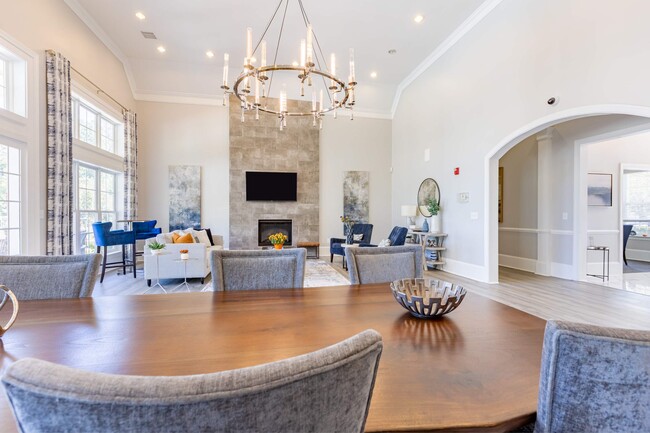 Chandelier and recessed lighting brighten spacious clubroom at Heron Lake