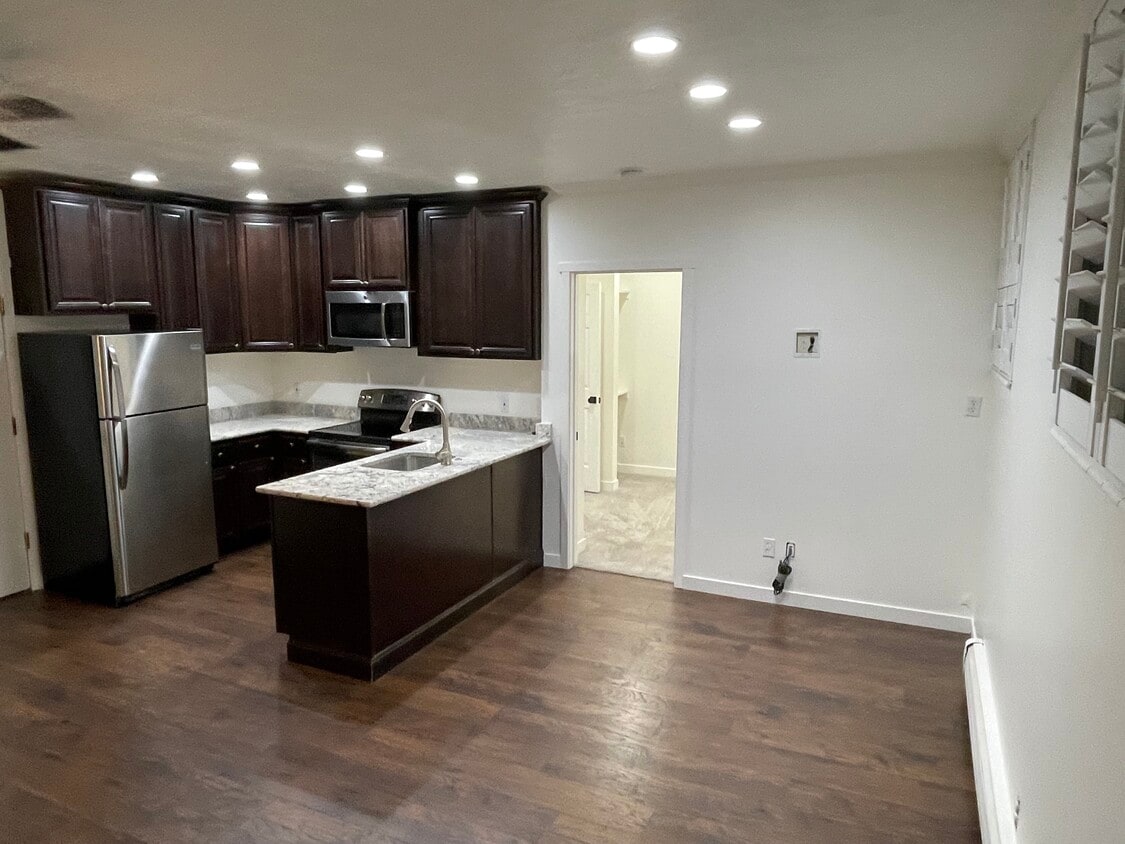 Kitchen. Bedroom door on right - 125 E 1st Ave (Salt Lake City, UT)