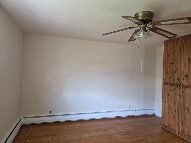 Main bedroom with walk in closet and a large wooden shelf - 20 W Marthart Ave