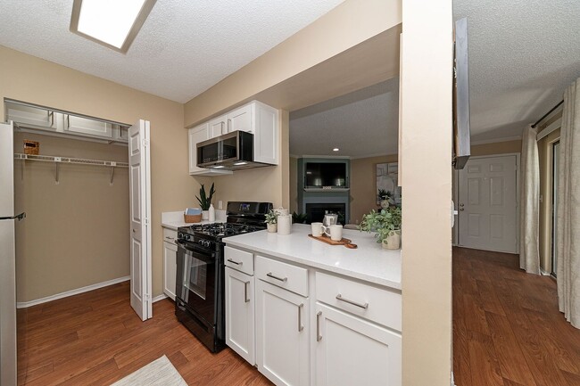 Kitchen with quartz counters & modern cabinetry - Vetra at Hamilton Place