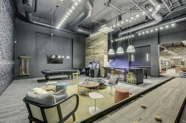 Game lounge with billiards, arcade games, and seating