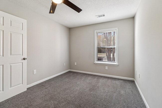 Comfortable rooms feature ceiling fans for climate control and window blinds for privacy, professionally operated by Highlands Vista Group.