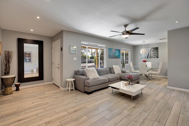 Bright, spacious living room with contemporary finishes and porcelain tile flooring - 6136 N 9th St