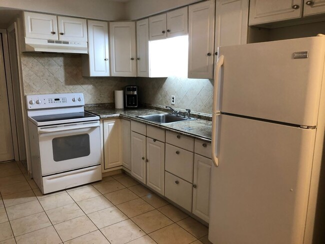Full stack kitchen with coffee maker, stove, oven, microwave, full size fridge and pots & pans. - 8315 Karam Blvd Unit 8315