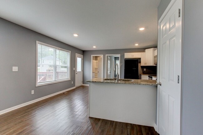 Photo - Two Story Duplex With Hardwood Flooring and White Cabinetry