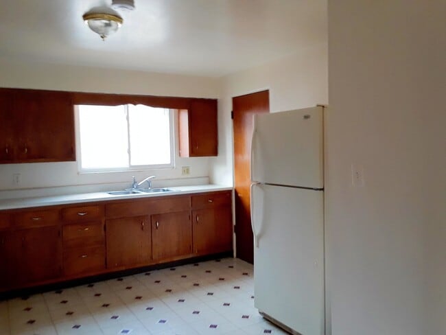 Large bright kitchen with large new refrigerator - 111 1st Ave W