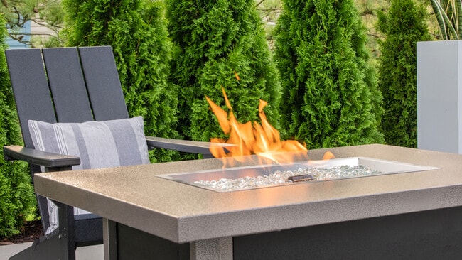 Gather around our modern outdoor fireplace for cozy evenings with friends and neighbors, professionally operated by Highlands Vista Group.