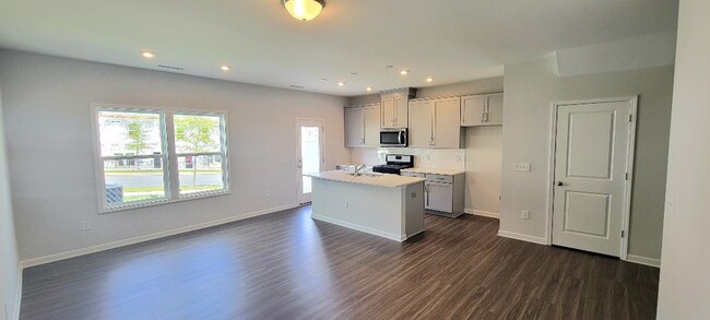 Open concept kitchen, walk-in pantry to the right, and spacious living/dining rm - 804 Oak Center Dr Townhome