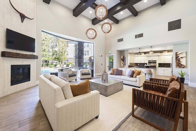Settle into the lounge and enjoy a comfortable space to relax, work, or connect with neighbors. - The Estates at Cougar Mountain