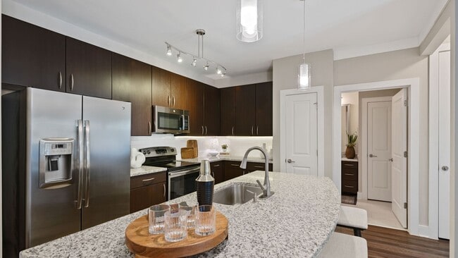 Kitchens with granite counters, subway tile backsplash and side-by-side stainless steel refrigerator with exterior ice/water dispenser
