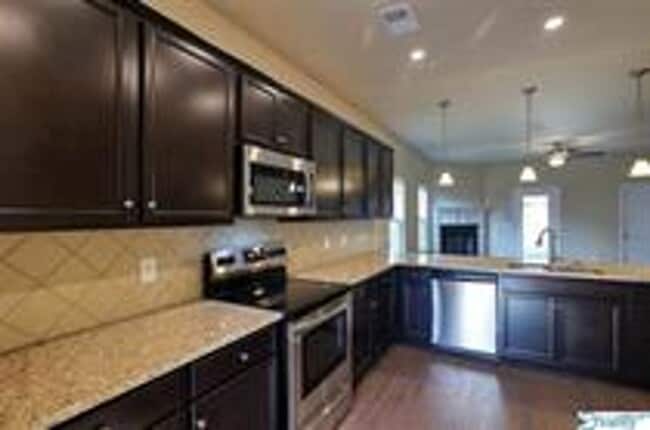 Photo - COMING SOON! Welcome to the Carlyle—where classic brick farmhouse charm meets a sleek, modern lif...